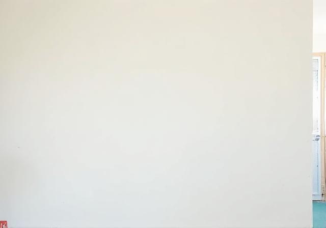 The same wall perfectly patched, textured, and painted.